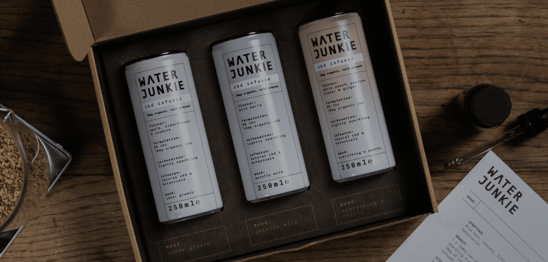 Water Junkie taster pack box open on a wooden surface revealing all three flavours