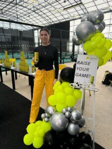 A portrait of E2 founder, Queenie Porter smiling with a can of Slazenger Energy Water at a brand activation