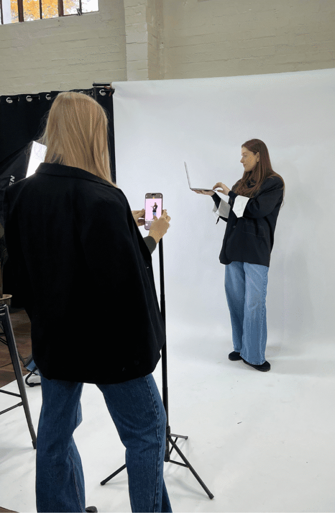 Behind-the-scenes shot of Kiwi Creative founders at content shoot